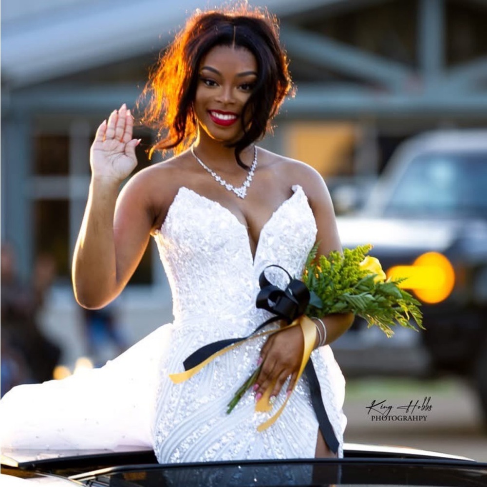 White homecoming or prom dress with white beading. The dress is a size 4.